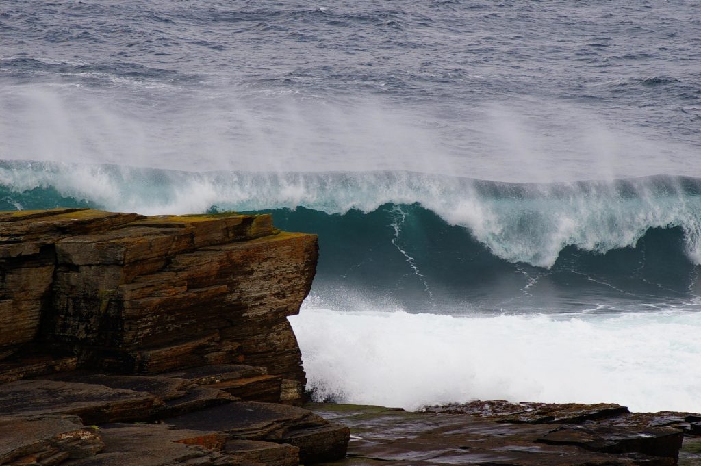 Wave next to a cliff